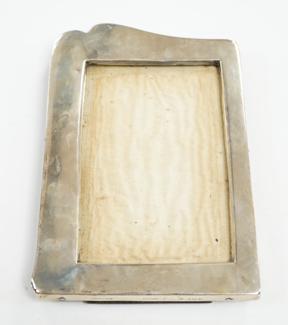 A George V silver mounted shaped photograph frame, Birmingham, 1912, 19.8cm. Condition - poor